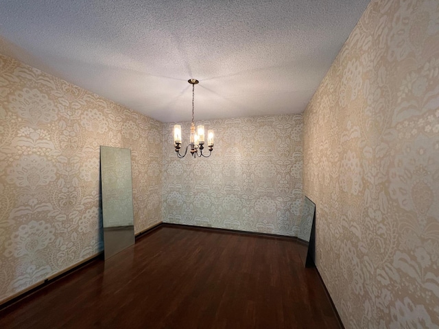2485 Londin Ln E Unit 418, Maplewood, MN 55119 - unfurnished room featuring wood finished floors, a chandelier, wallpapered walls, and a textured ceiling