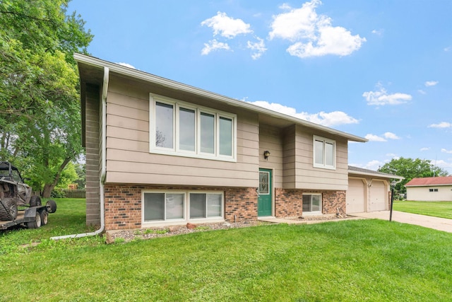 540 4th St E, Wanamingo, MN 55983 - bi-level home with a front yard, concrete driveway, a garage, and brick siding
