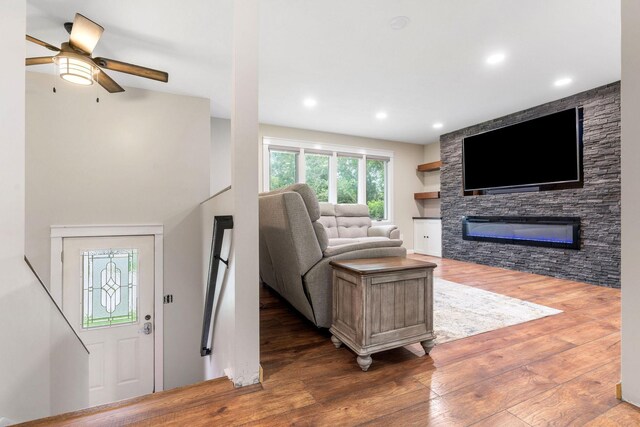 540 4th St E, Wanamingo, MN 55983 - living area with wood finished floors, ceiling fan, a fireplace, and recessed lighting