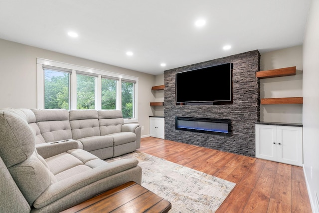 540 4th St E, Wanamingo, MN 55983 - living area featuring light wood-style flooring, a fireplace, and recessed lighting