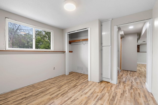 540 4th St E, Wanamingo, MN 55983 - unfurnished bedroom featuring light wood-type flooring and a closet