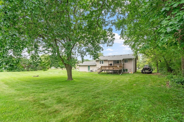 540 4th St E, Wanamingo, MN 55983 - view of grassy yard with a wooden deck and stairs