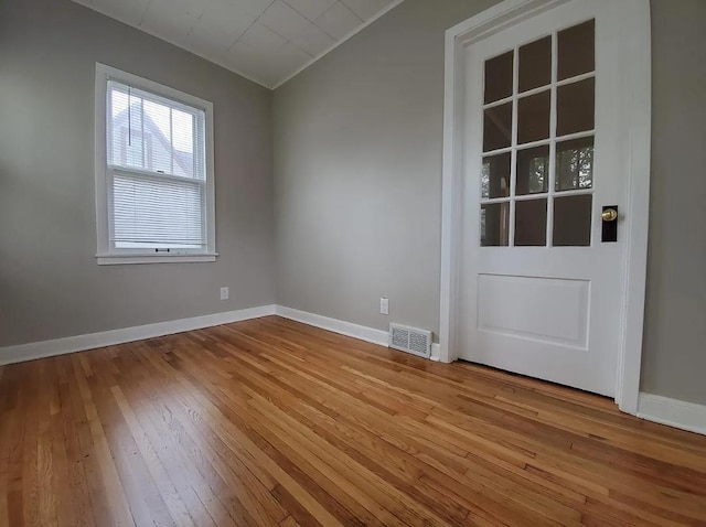 1138 7th Ave SE, Rochester, MN 55904 - empty room featuring hardwood / wood-style floors and lofted ceiling
