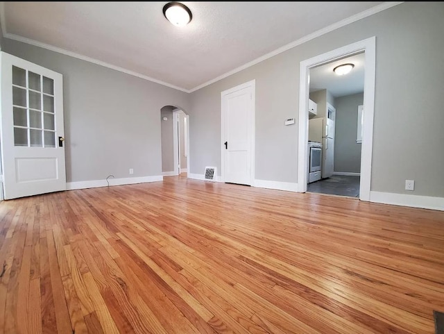 1138 7th Ave SE, Rochester, MN 55904 - unfurnished room featuring light wood-style floors, arched walkways, and ornamental molding