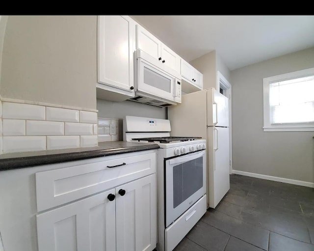 1138 7th Ave SE, Rochester, MN 55904 - kitchen featuring white appliances, dark countertops, white cabinetry, and dark tile patterned floors