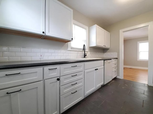 1138 7th Ave SE, Rochester, MN 55904 - kitchen with dishwasher, healthy amount of natural light, dark countertops, and decorative backsplash