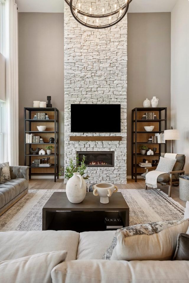 14540 106th Pl N, Maple Grove, MN 55369 - living room featuring a chandelier, a stone fireplace, and wood finished floors