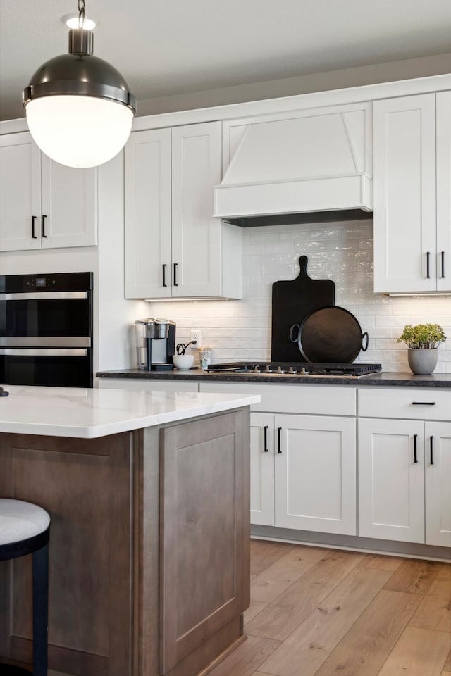 14540 106th Pl N, Maple Grove, MN 55369 - kitchen featuring custom range hood, double oven, stovetop, and backsplash