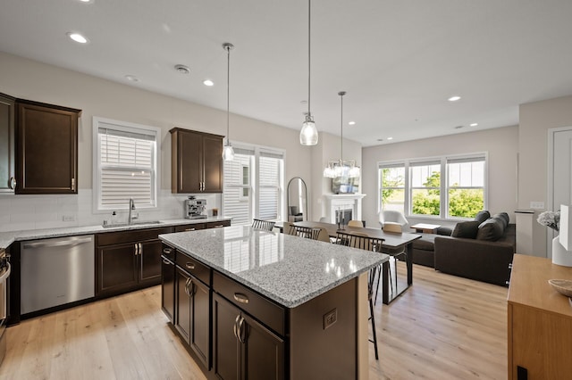 8120 Arrowwood Ln N, Maple Grove, MN 55369 - kitchen featuring light wood finished floors, stainless steel dishwasher, dark brown cabinets, a center island, and recessed lighting