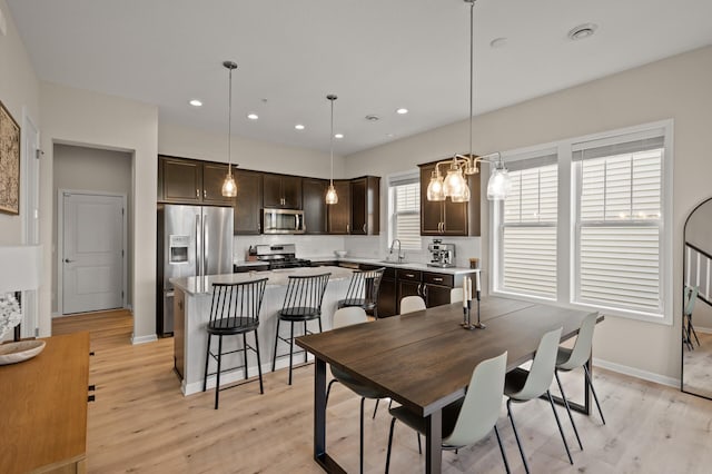 8120 Arrowwood Ln N, Maple Grove, MN 55369 - dining room with light wood-style floors, recessed lighting, and a chandelier