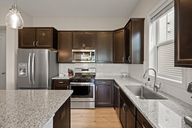 8120 Arrowwood Ln N, Maple Grove, MN 55369 - kitchen featuring stainless steel appliances, dark brown cabinets, light stone countertops, backsplash, and light wood finished floors