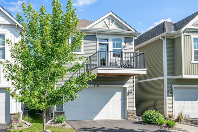 8120 Arrowwood Ln N, Maple Grove, MN 55369 - view of front facade with a balcony, an attached garage, concrete driveway, and stone siding