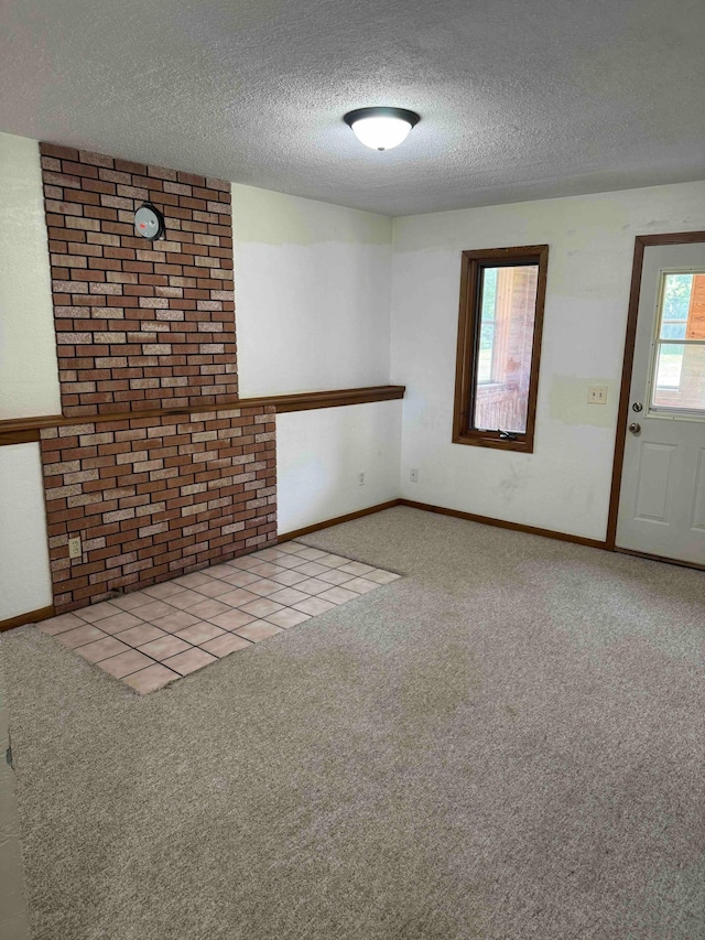 18627 148th St NW, Big Lake Twp, MN 55330 - carpeted empty room with a textured ceiling and brick wall