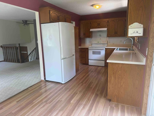 18627 148th St NW, Big Lake Twp, MN 55330 - kitchen featuring white appliances, light countertops, light wood-style flooring, ceiling fan, and under cabinet range hood