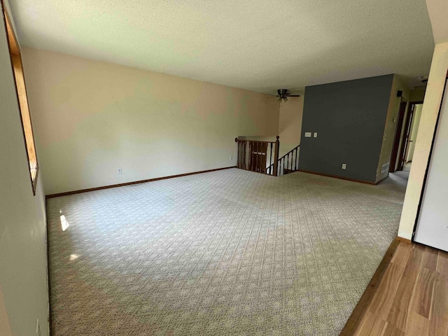 18627 148th St NW, Big Lake Twp, MN 55330 - spare room with a textured ceiling, carpet flooring, a ceiling fan, and wood finished floors