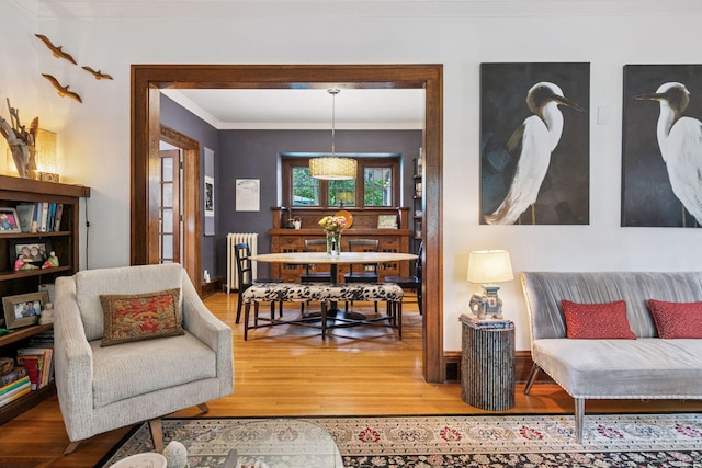 2612 52nd St, Minneapolis, MN 55410 - living area featuring light wood-style floors, crown molding, and radiator heating unit