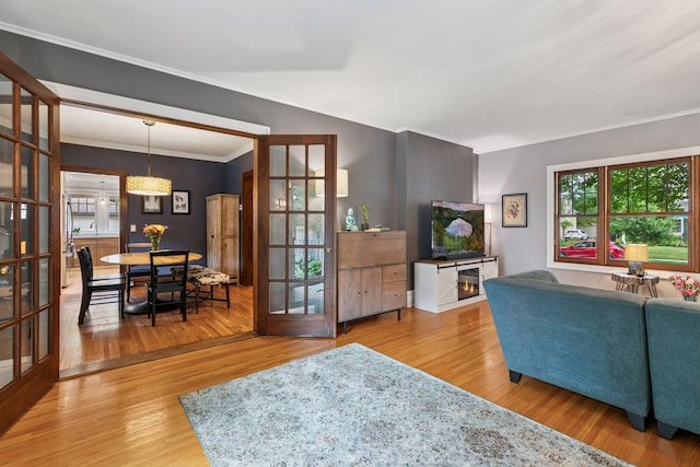 2612 52nd St, Minneapolis, MN 55410 - living area featuring plenty of natural light, wood finished floors, french doors, and ornamental molding
