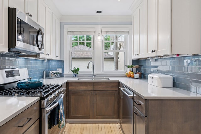 2612 52nd St, Minneapolis, MN 55410 - kitchen featuring stainless steel appliances, light countertops, and white cabinets