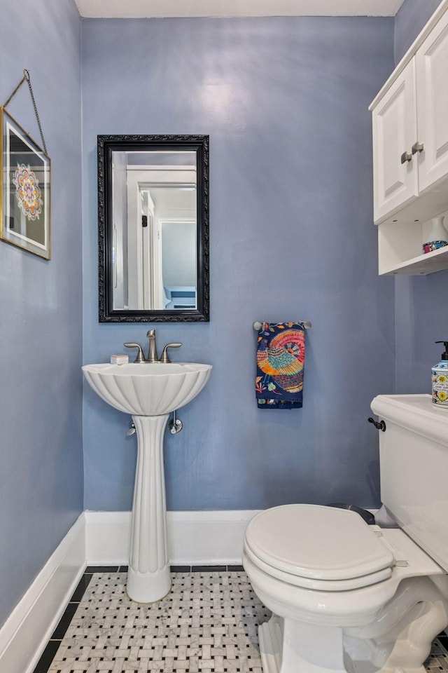 2612 52nd St, Minneapolis, MN 55410 - half bathroom with baseboards and tile patterned floors