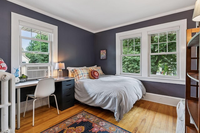 2612 52nd St, Minneapolis, MN 55410 - bedroom with light wood finished floors, multiple windows, radiator, ornamental molding, and cooling unit