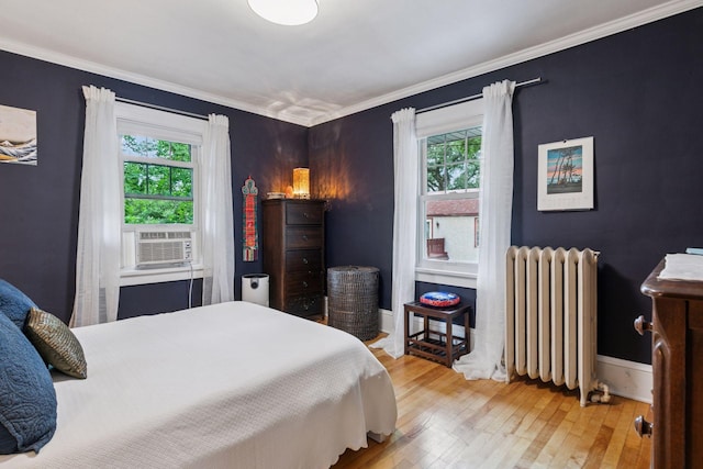 2612 52nd St, Minneapolis, MN 55410 - bedroom featuring radiator heating unit, hardwood / wood-style floors, ornamental molding, and cooling unit
