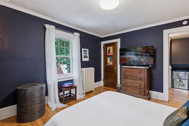 2612 52nd St, Minneapolis, MN 55410 - bedroom with radiator heating unit, wood finished floors, and crown molding