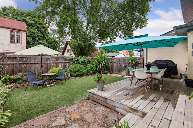 2612 52nd St, Minneapolis, MN 55410 - wooden terrace featuring outdoor dining area, a fenced backyard, and a grill