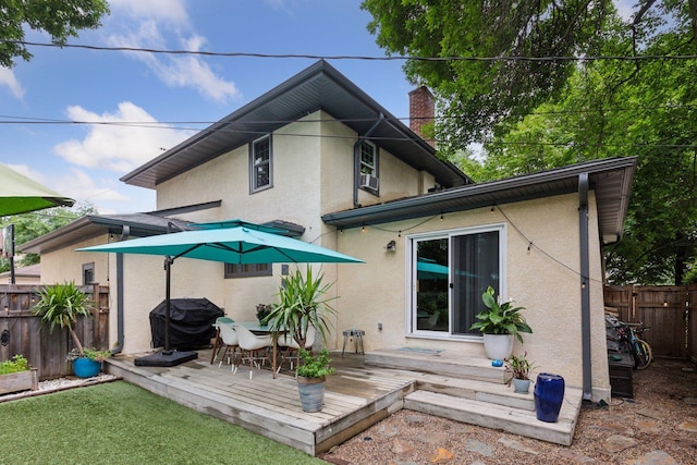 2612 52nd St, Minneapolis, MN 55410 - rear view of house with a deck, stucco siding, and a chimney
