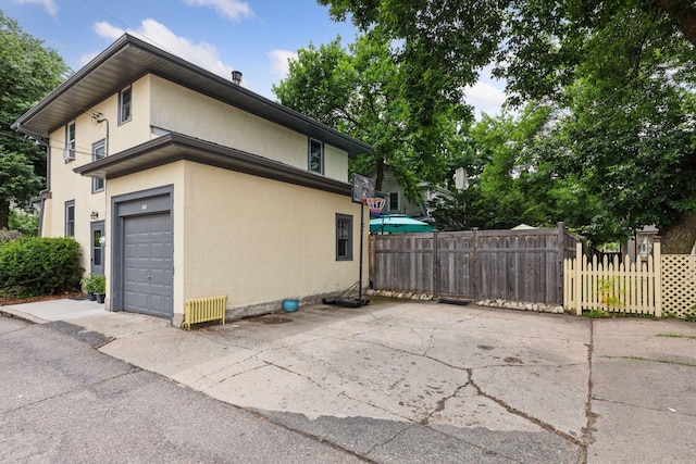 2612 52nd St, Minneapolis, MN 55410 - view of side of property featuring stucco siding and a garage