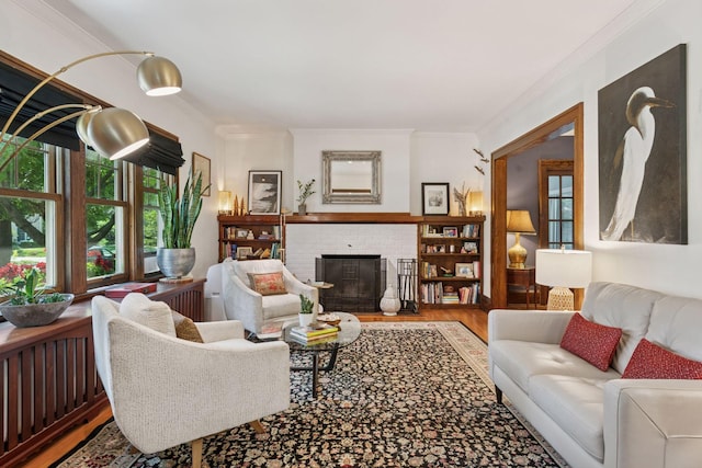 2612 52nd St, Minneapolis, MN 55410 - living area featuring wood finished floors, a brick fireplace, and ornamental molding