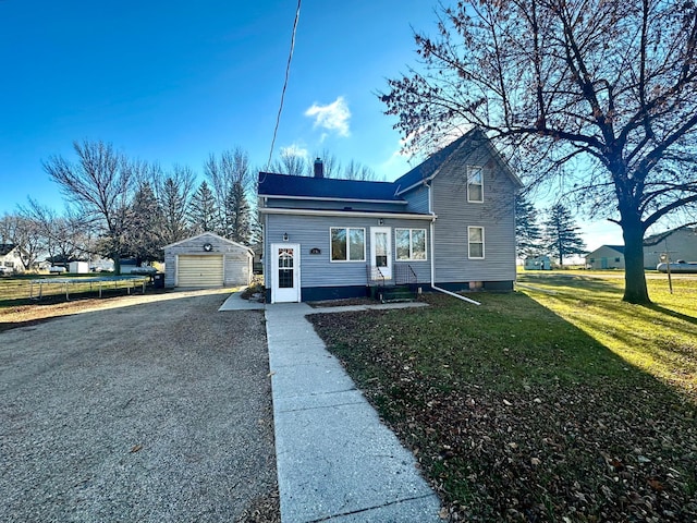 2716 Canterbury Dr, Bigelow, MN 56117 - view of front facade with a detached garage, an outdoor structure, a chimney, driveway, and a front yard