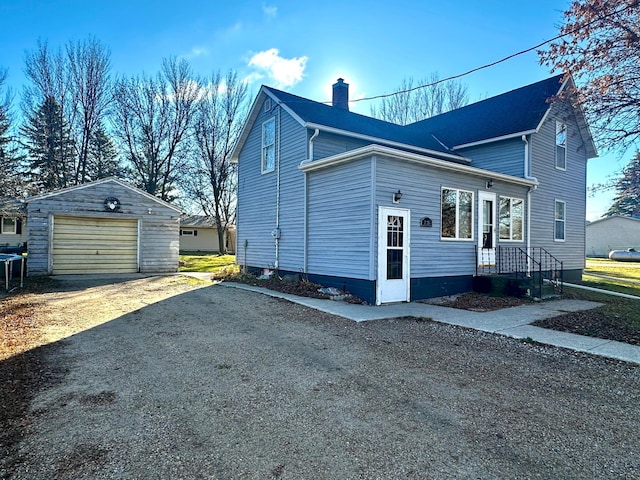 2716 Canterbury Dr, Bigelow, MN 56117 - view of property exterior with dirt driveway, a chimney, an outdoor structure, and a garage