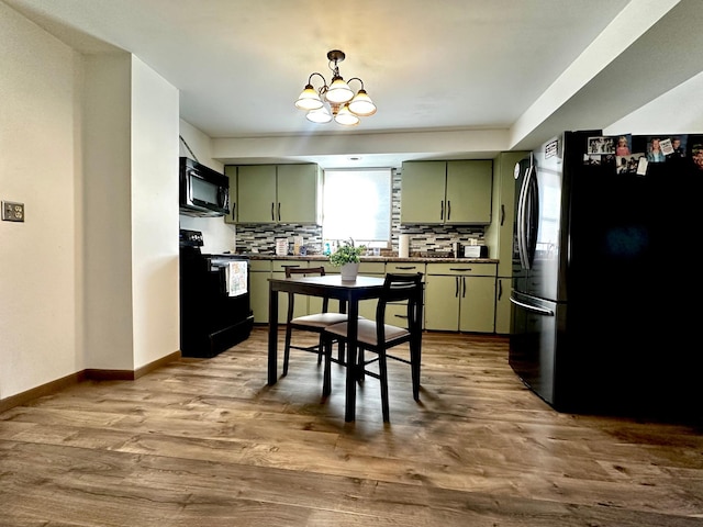 2716 Canterbury Dr, Bigelow, MN 56117 - kitchen featuring black appliances, green cabinetry, tasteful backsplash, and a chandelier