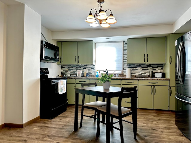2716 Canterbury Dr, Bigelow, MN 56117 - kitchen with green cabinetry, black appliances, dark countertops, and tasteful backsplash