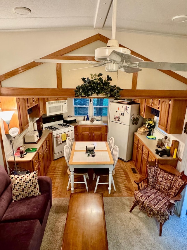 15827 Wilderness Trl Unit 127, Crosslake, MN 56442 - kitchen featuring white appliances, brown cabinetry, light wood-style flooring, and light countertops