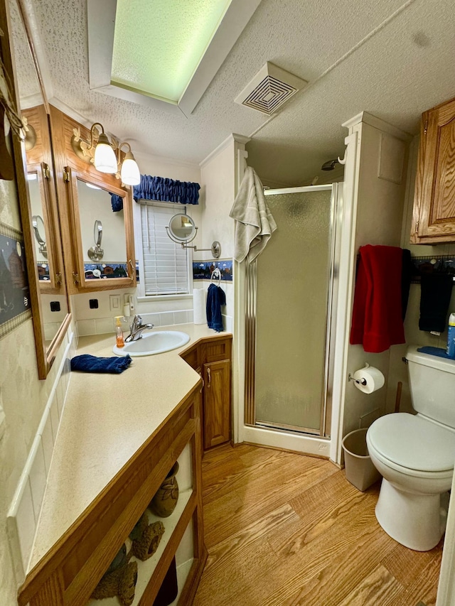 15827 Wilderness Trl Unit 127, Crosslake, MN 56442 - bathroom featuring a shower stall, vanity, wood finished floors, and a textured ceiling