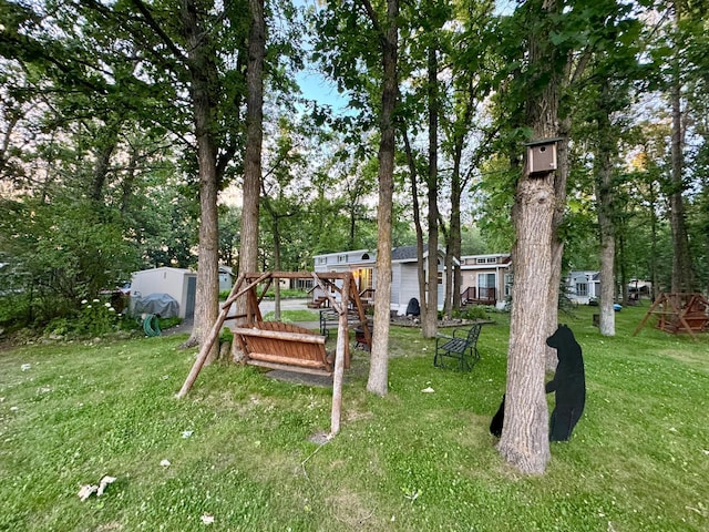 15827 Wilderness Trl Unit 127, Crosslake, MN 56442 - view of green lawn with view of wooded area and an outbuilding