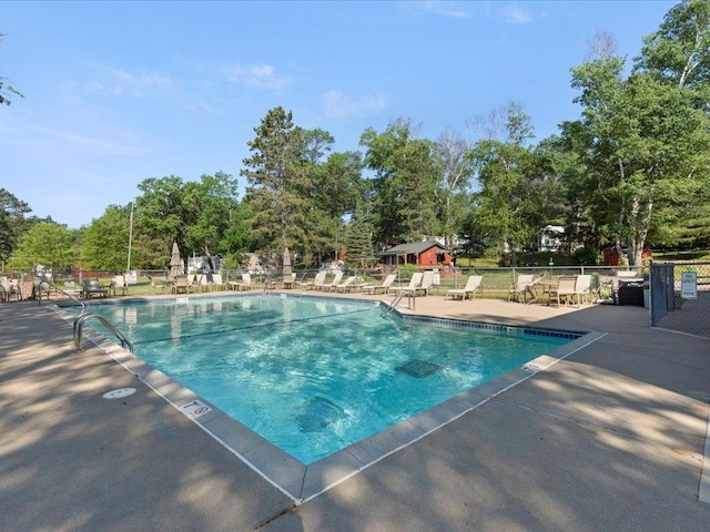 15827 Wilderness Trl Unit 127, Crosslake, MN 56442 - community pool featuring a patio area and view of scattered trees