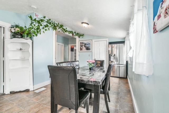 400 Blair Ave, Saint Paul, MN 55103 - dining area featuring lofted ceiling and stone finish floors