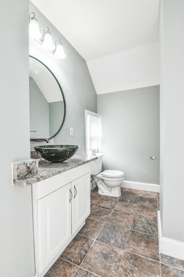 400 Blair Ave, Saint Paul, MN 55103 - bathroom featuring vanity, stone finish flooring, and lofted ceiling