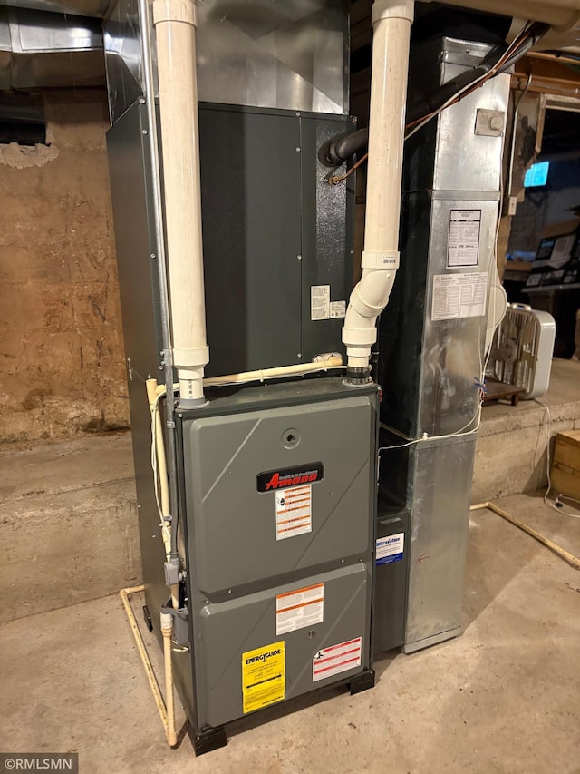 W5168 Lake Rd, Warner Twp, WI 54437 - utility room featuring heating unit
