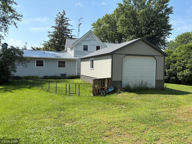 W5168 Lake Rd, Warner Twp, WI 54437 - view of property exterior with a garage, an outbuilding, and a metal roof