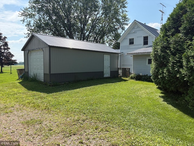 W5168 Lake Rd, Warner Twp, WI 54437 - rear view of house featuring an outbuilding, a garage, a metal roof, and a yard