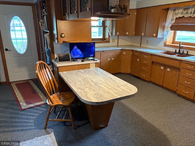 W5168 Lake Rd, Warner Twp, WI 54437 - kitchen featuring light countertops, brown cabinets, dark carpet, and an office area