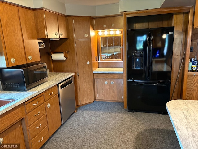W5168 Lake Rd, Warner Twp, WI 54437 - kitchen with appliances with stainless steel finishes, brown cabinetry, light countertops, and light carpet
