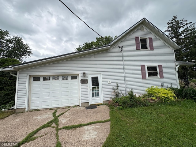 W5168 Lake Rd, Warner Twp, WI 54437 - view of front of house with driveway, a garage, and a front yard