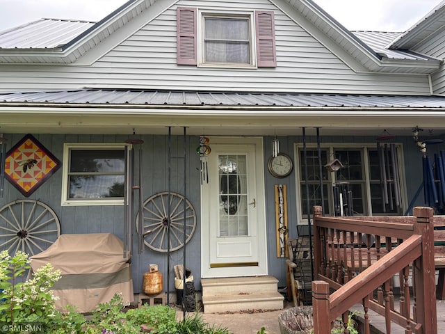 W5168 Lake Rd, Warner Twp, WI 54437 - view of exterior entry featuring a metal roof and a porch