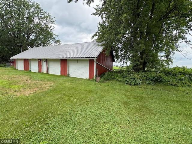 W5168 Lake Rd, Warner Twp, WI 54437 - view of green lawn featuring an outbuilding and a garage