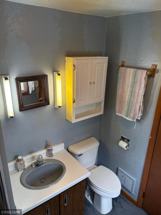 W5168 Lake Rd, Warner Twp, WI 54437 - bathroom featuring vanity and toilet