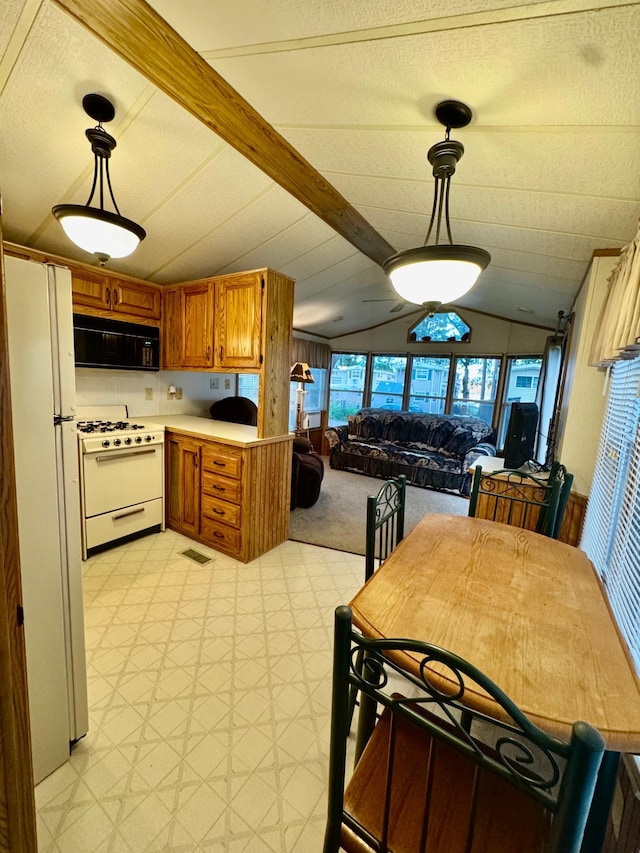 15827 Wilderness Trl Unit 28, Crosslake, MN 56442 - kitchen featuring white appliances, brown cabinetry, open floor plan, light countertops, and light flooring